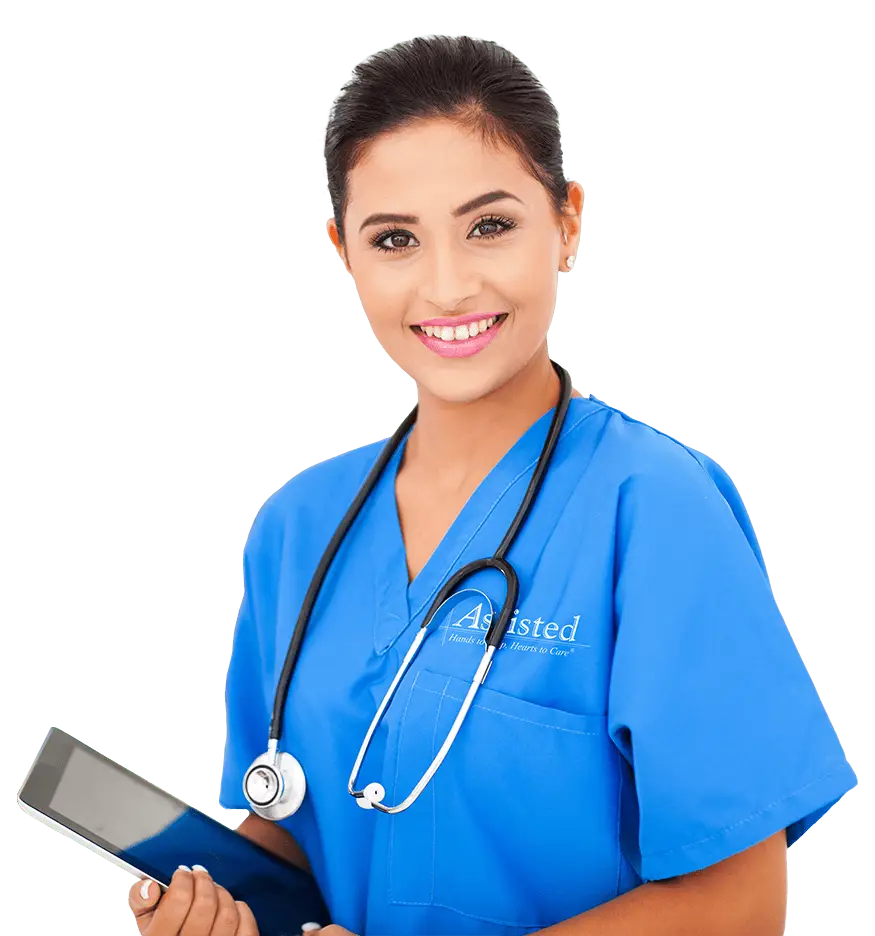 A healthcare professional in blue scrubs with a stethoscope around her neck holds a tablet and smiles toward the camera, representing the spirit of LA LVN Recruitment.